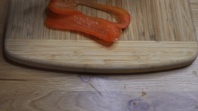 Slicing red pepper with cleaver, dolly shot forward and over - Powered by Shutterstock - Get 15% off with code: PIKWIZARD15