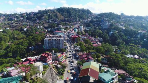 Pull Out Slow Motion Aerial Shot Of Traffic On Top Of Mountains In Baguio Philippines