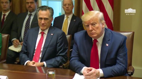 CIRCA 2019 - U.S. President Donald Trump and Senator Mitt Romney sit beside each other at a meeting at the White House.