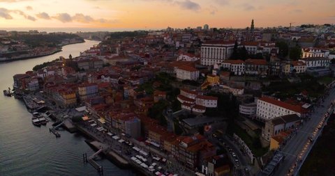 Drone approach of Porto, Portugal and River Douro at sunset toward coast.