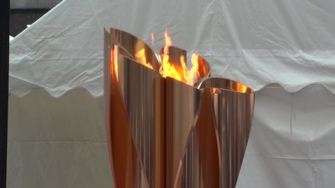 FUKUSHIMA, JAPAN - 24 MARCH 2020 : Olympic Flame displayed at Fukushima station. Tokyo Olympic 2020 have been postponed to 2021 due to coronavirus. Close up shot of relay torch. Slow motion shot.