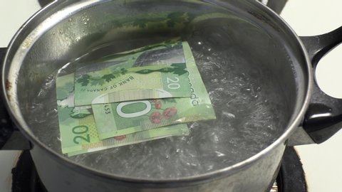 Toronto, Ontario, Canada March 30 2020Boiling money to clean and disinfect it during COVID 19 coronavirus pandemic in Toronto 