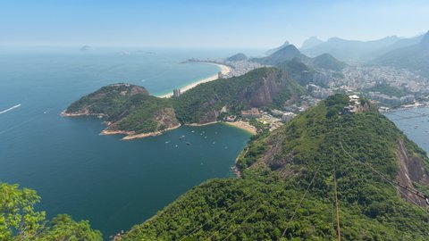 Wide panoramic aerial timelapse of the city of Rio de Janeiro in Brazil. View of Copacabana, Ipanema, Botafogo, Flamengo neighborhoods. Ocean and bay, hills and mountains 