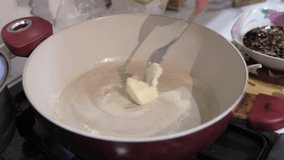 butter melted in a frying steel pan with using fork