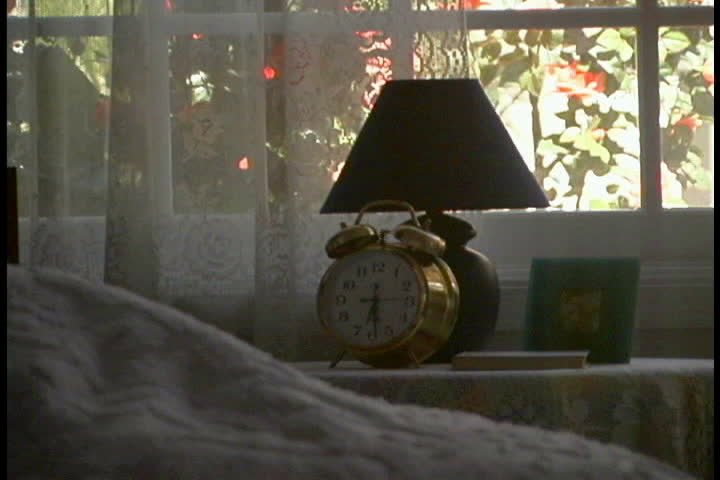 Hand turning off alarm clock