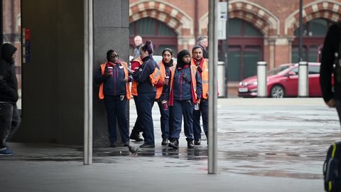 LONDON - MARCH 19, 2020: London Underground staff on a break outside of King's Cross St. Pancras Underground Station