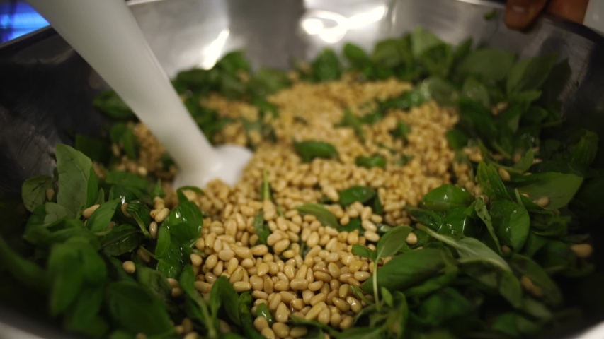 A close up of pesto making, chef is making the homemade pesto for pizzas with a blender	
