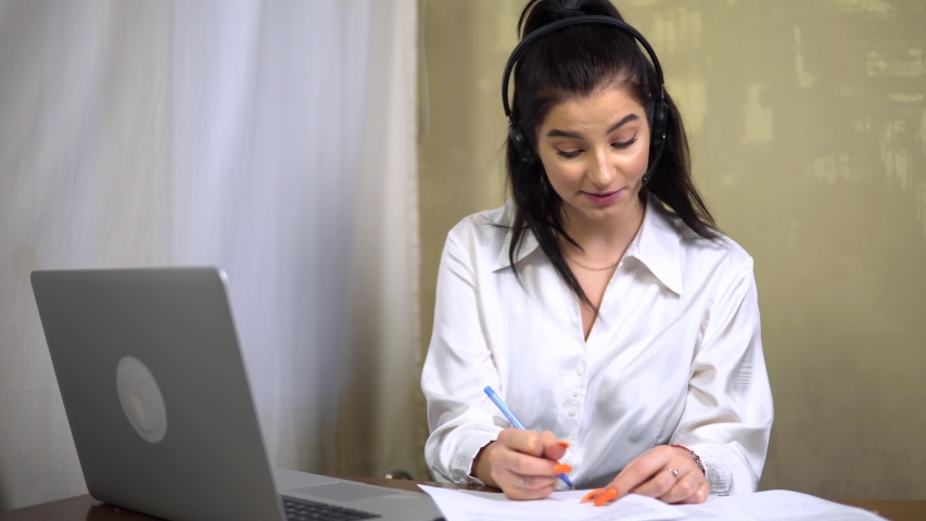 phone operator focus on sales agent youg woman in headset answers calls talk with client provide professional support to customers sell company, secretary work with document