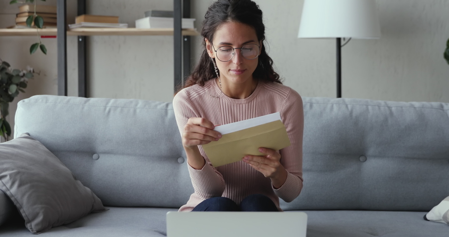 Stressed worried young woman reading bad news in paper mail letter at home. Desperate lady frustrated about bankruptcy, financial problem, receiving bank debt penalty, high bills, lost job concept. Royalty-Free Stock Footage #1049471824