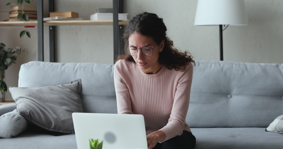 Exhausted young woman taking off glasses massaging dry irritable eyes. Tired overworked lady feeling eye strain after using computer working from home. Headache, visual fatigue and eyestrain concept. | Shutterstock HD Video #1049471836