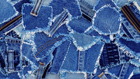Denim jeans background. Destroyed torn classic denim blue jeans patches, fashion backdrop