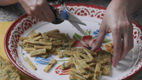 Home cook hands cutting Malaysian traditional snack locally known as 