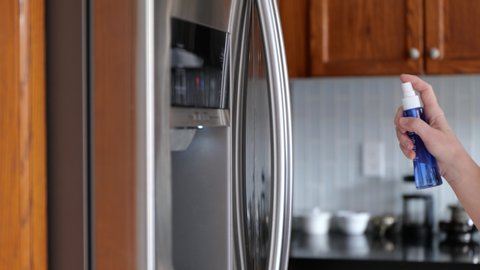fridge door handle Disinfecting with Spray Sanitizer Paper Towel Corona virus