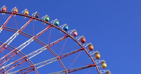 A ferris wheel at the amusement park daytime long shot. Koutou district Odaiba Tokyo Japan - 04.15.2019