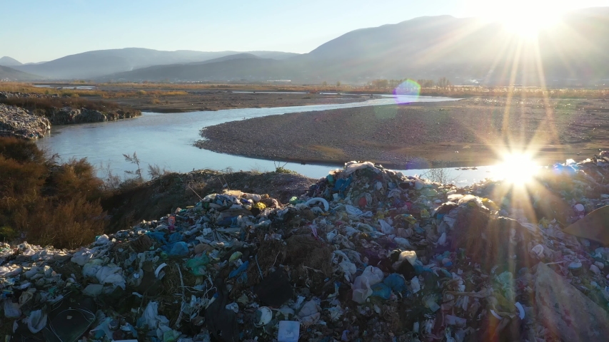 dump site next to a river washing plastic into the ocean Royalty-Free Stock Footage #1049498308