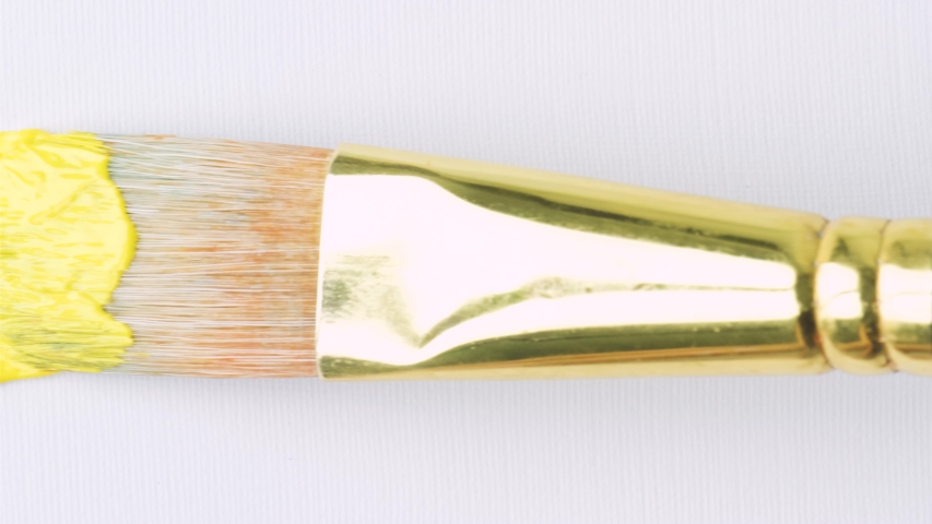 Close-up of artist holding paint brush and drawing oil painting. Painting yellow line on canvas. Royalty-Free Stock Footage #1049502079