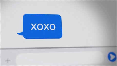 xoxo - kisses and hugs text message on chat - close up on screen
