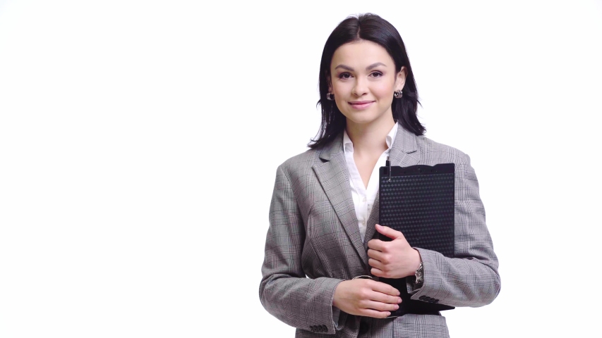 Businesswoman holding clipboard, smiling and showing like sign isolated on white