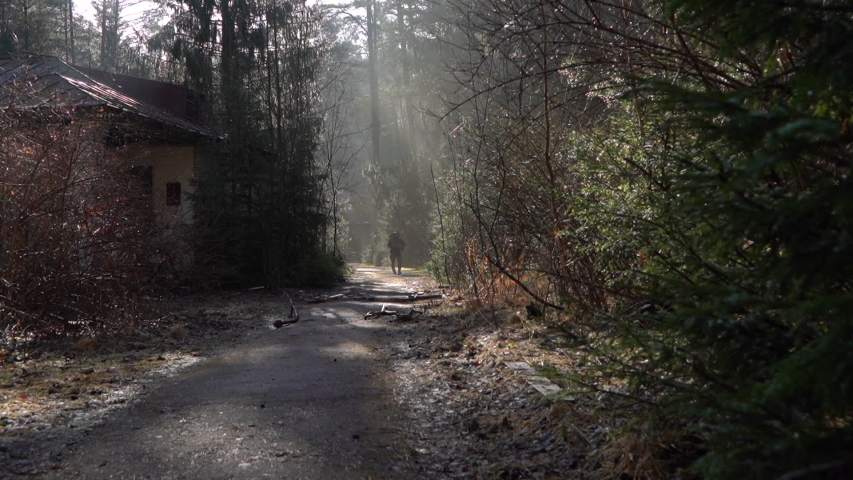 a soldier goes through abandoned buildings