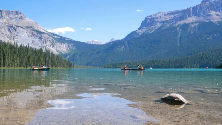 summer clear blue lake view -Emerald Lake with people while canoeing in lake and beautiful mountain range with clear blue sky in summer holiday in yoho/banff national park,Alberta,Canada