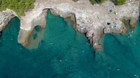 Grotto of Pula town, clean blue water of Adriatic sea with rocky beach, Istria region