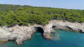 Grotto of Pula town, clean blue water of Adriatic sea with rocky beach, Istria region