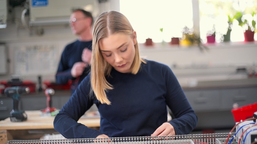 Female electrician working with wire cutter
