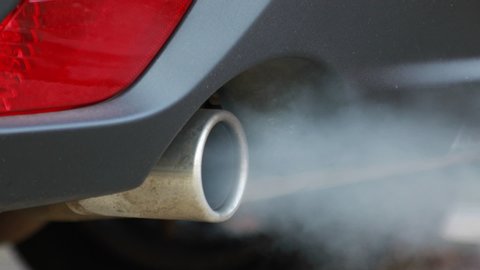 Smoke emissions fumes from car exhaust tailpipe causing air pollution and smog
