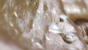 Metallic Gold and White Paint on Hands Macro - Macro shot of metallic gold and white paint dripping on hands. - Powered by Shutterstock - Get 15% off with code: PIKWIZARD15