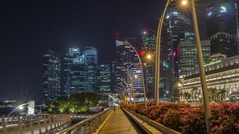 Business Financial Downtown City and Skyscrapers Tower Building at Marina Bay night timelapse hyperlapse, Singapore, Cityscape Urban Landmark and Business Finance District Center from esplanade