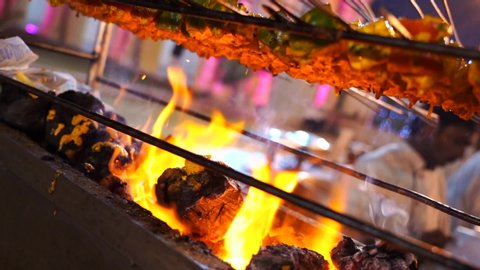 Jaipur,Rajasthan/India - january 10 2020: cooking paneer cottage cheese over fire grill slow motion