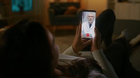 Young Girl Sick at Home Using Smartphone to Talk to Her Doctor via Video Conference Medical App. Woman Has Conversation with Professional Physician, Using Online Video Chat Application. Late at Night