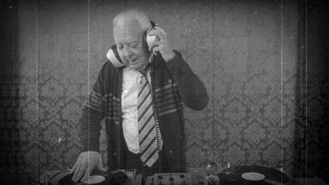 Scratched film of a funky DJ grandpa dancing and playing records in nightclub