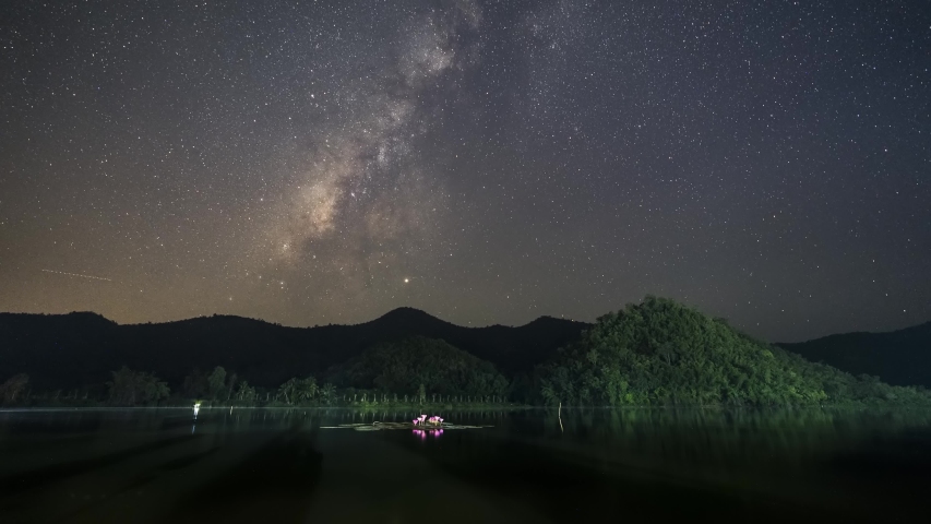 Time lapse of milky way and cloudy at  raining season in dam