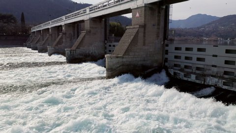 Dam with flowing water at hydroelectric power station located south of Lake Como.