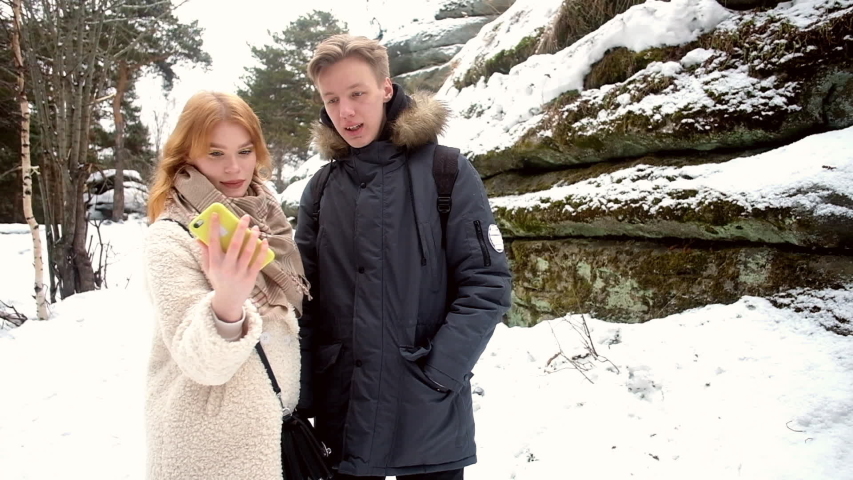 young couple is photographed in winter at the rocks