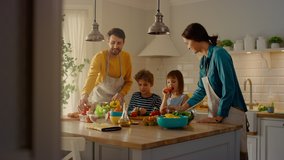 In the Kitchen: Family of Four Cooking Together Healthy Dinner. Mother, Father, Little Boy and Girl, Preparing Salads, Washing and Cutting Vegetables. Cute Children Helping their Caring Parents - Powered by Shutterstock - Get 15% off with code: PIKWIZARD15