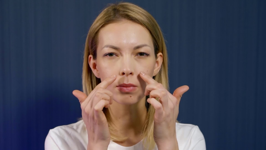 domestic treatments for keeping young, woman is performing gymnastics for face