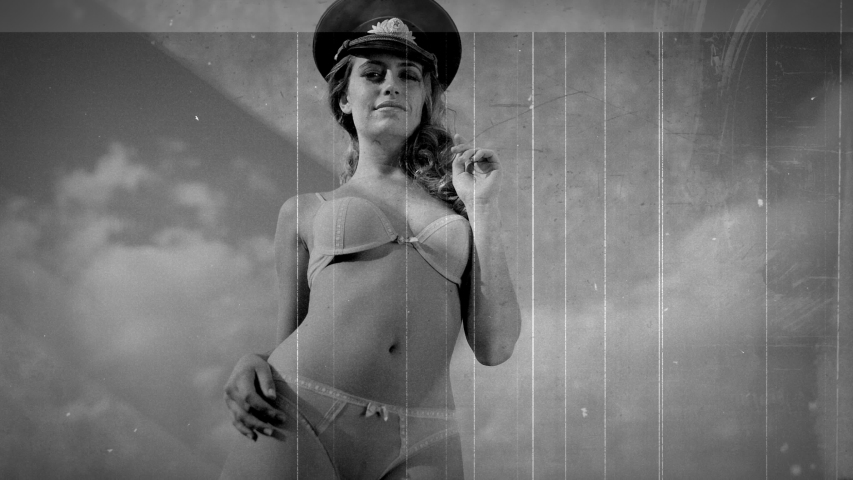 Scratched vintage celluloid film of a young woman in lingerie  and military hat smiling at camera.
