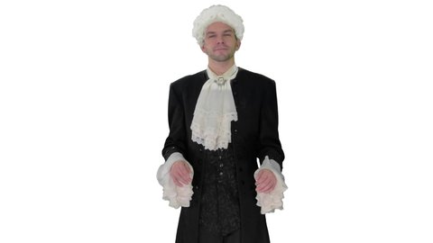 Man in 18th century camisole and wig doing welcoming gesture on white background.