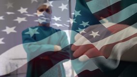Animation of US flag waving over male and female doctors wearing protective clothing and face mask standing in a surgery room, looking at the camera in the background. Medicine public health pandemic - Powered by Shutterstock - Get 15% off with code: PIKWIZARD15