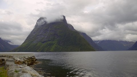 Clouds covering the mountain top in a Norwegian fjord - Static shot