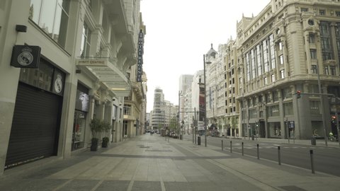 MADRID, SPAIN - MARCH 15 2020. Gimbal shot of eerily empty Gran Via, one of the usually crowdest avenues in downtown Madrid, during the first day of coronavirus lockdown.