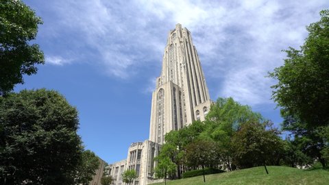 Pittsburgh, PA / USA - March 30, 2019: University of Pittsburgh Oakland Campus Cathedral of Learning Coronavirus Victory Lights Summer Fall Spring Winter Aerial 4K