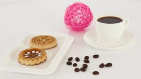 Cup of black coffee with cookies on table background. *UHD