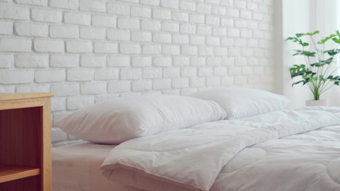 bed with white pillow and blanket with natural light in bedroom in the morning,bed and Cozy Bedroom Concept