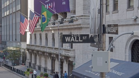 NYC, USA – JUNE 26, 2019: New York Stock Exchange building exterior and Wall Street Nassau signpost, daytime 