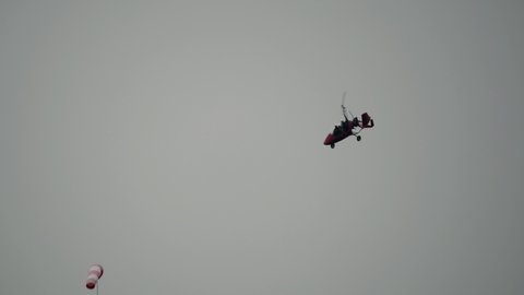 Gyroplane flying in the sky over the airfield. Aviation festival holiday at the aerodrome airport 