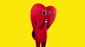 person in heart costume touching cartoon eyes isolated on yellow