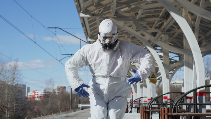 Dancing epidemiologist doctor after epidemic of coronavirus COVID-19 finished. Concept of global pandemic positive end. Funny virologist working in protective suit, glasses, gloves, mask. Royalty-Free Stock Footage #1049691115